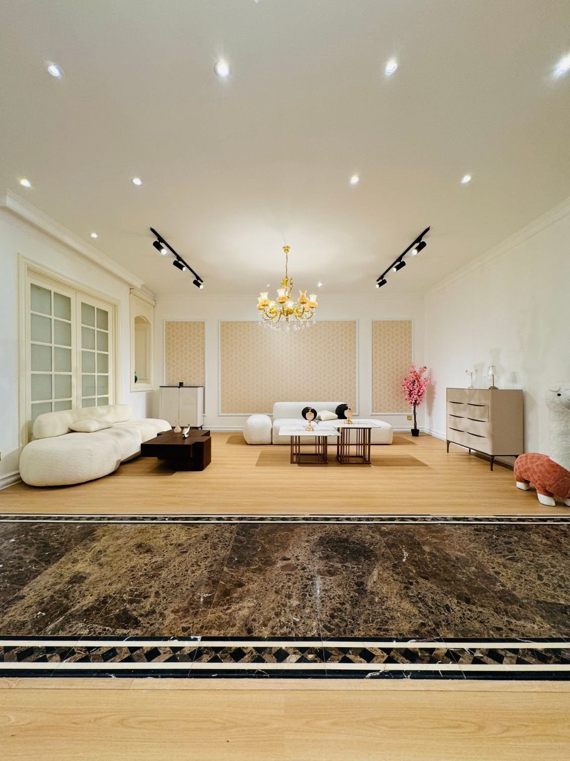 Flooring Service in Dubai featuring elegant wood flooring in a modern luxury living room with custom sofas.